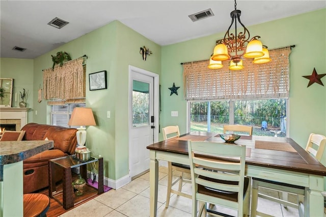 dining space with a chandelier and light tile patterned floors