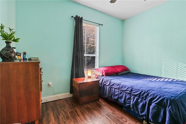 bedroom with ceiling fan and dark wood-type flooring