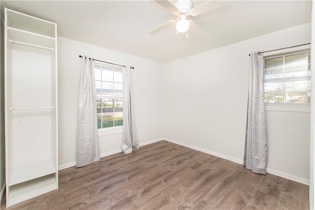 unfurnished bedroom featuring hardwood / wood-style floors, ceiling fan, and a closet