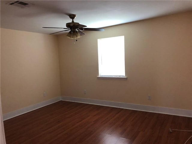 empty room featuring ceiling fan and dark hardwood / wood-style flooring