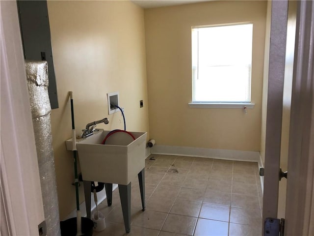 office area with light tile patterned floors and sink