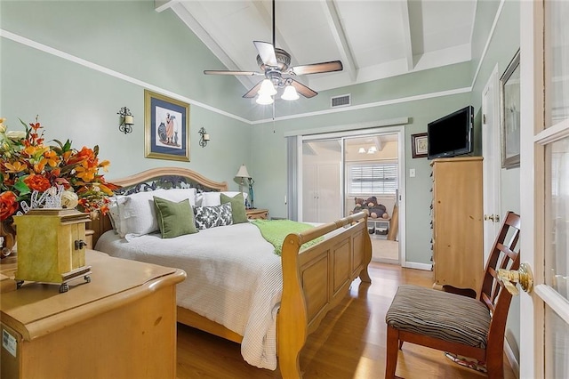 bedroom with vaulted ceiling with beams, light wood-type flooring, and ceiling fan