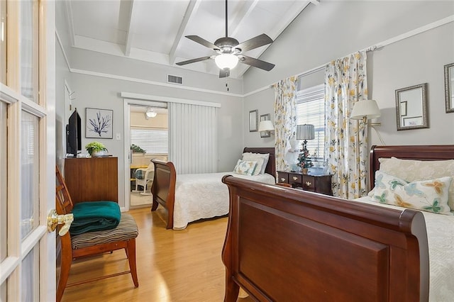 bedroom featuring light wood-type flooring, lofted ceiling with beams, and ceiling fan