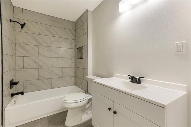 full bathroom featuring tile patterned floors, vanity, toilet, and tiled shower / bath