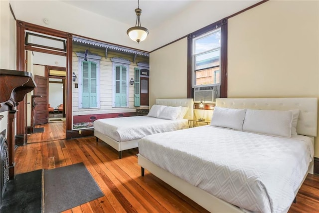 bedroom featuring cooling unit and dark wood-type flooring