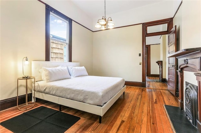 bedroom featuring hardwood / wood-style flooring and a notable chandelier