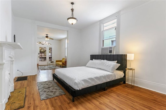 bedroom featuring hardwood / wood-style floors and cooling unit