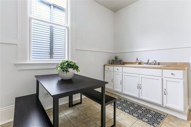 dining room featuring light tile patterned floors and sink