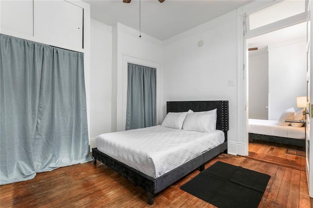 bedroom with ceiling fan and hardwood / wood-style flooring