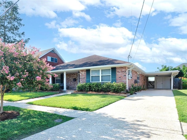 view of front of house with a front lawn and a carport