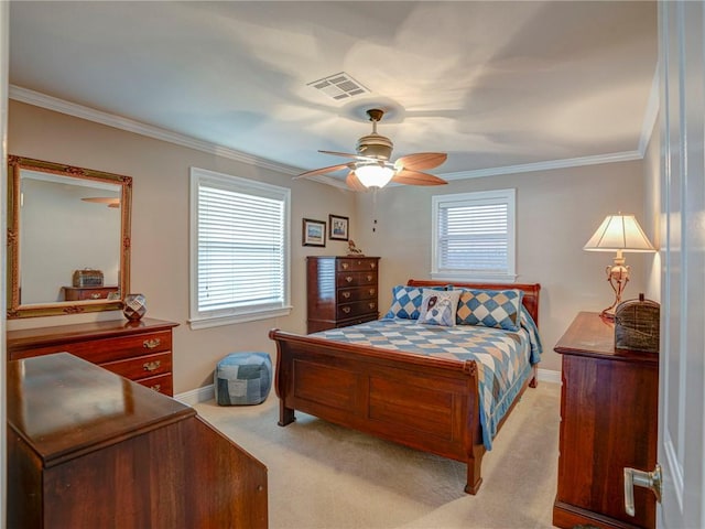 bedroom with ceiling fan, crown molding, and light colored carpet