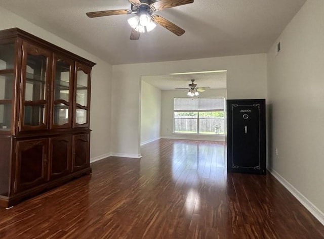 spare room with ceiling fan and dark wood-type flooring