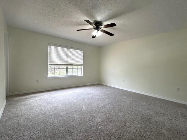 carpeted spare room featuring ceiling fan and a textured ceiling