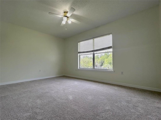 carpeted empty room with ceiling fan and a textured ceiling