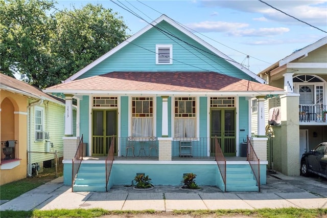 back of house featuring a porch