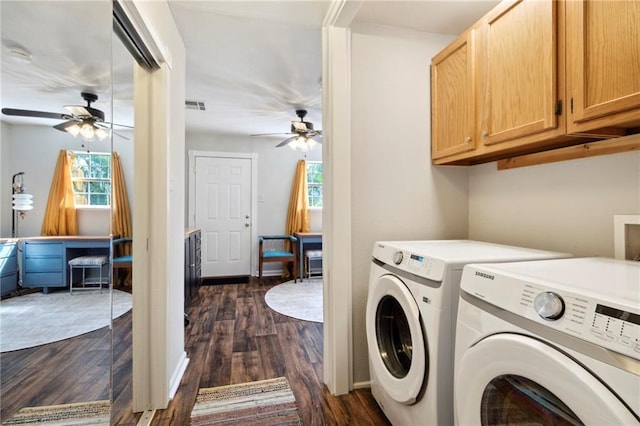 clothes washing area featuring dark hardwood / wood-style flooring, cabinets, plenty of natural light, and washing machine and dryer