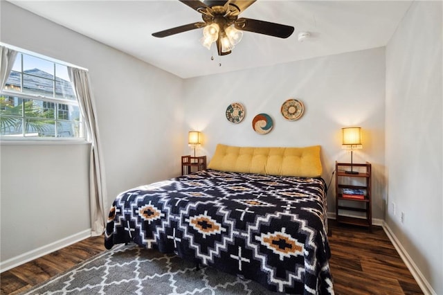 bedroom with dark hardwood / wood-style flooring and ceiling fan