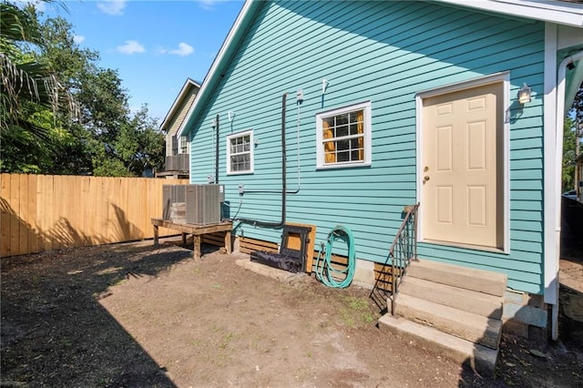 back of property featuring central AC unit