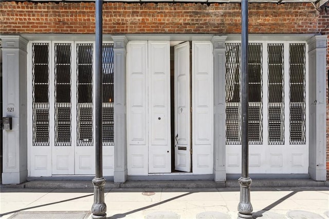 exterior space featuring brick wall