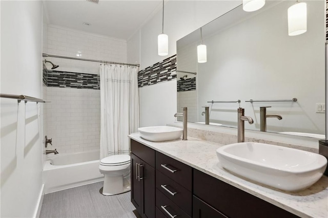 full bathroom with shower / tub combo with curtain, vanity, and toilet