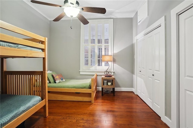 bedroom featuring ceiling fan, dark hardwood / wood-style flooring, and ornamental molding