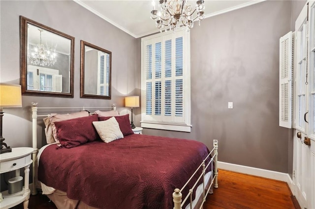 bedroom with hardwood / wood-style flooring, crown molding, and a chandelier