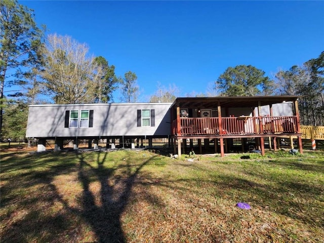 rear view of house with a yard and a deck