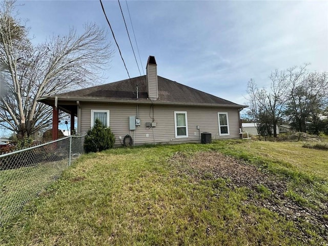 rear view of property featuring a lawn