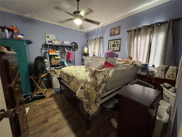 bedroom with hardwood / wood-style flooring, ceiling fan, and ornamental molding