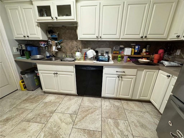 kitchen with backsplash, white cabinets, sink, and black dishwasher