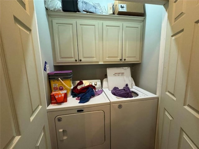 laundry room with cabinets and washing machine and dryer