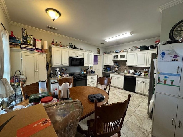 kitchen with black appliances, crown molding, light tile patterned floors, tasteful backsplash, and white cabinetry