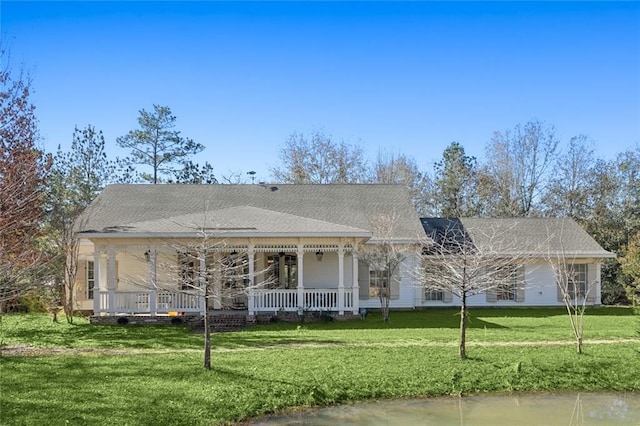 view of front of home with a porch, a water view, and a front yard