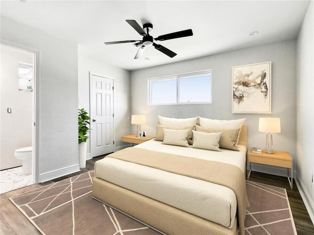 bedroom featuring connected bathroom, ceiling fan, and dark hardwood / wood-style flooring