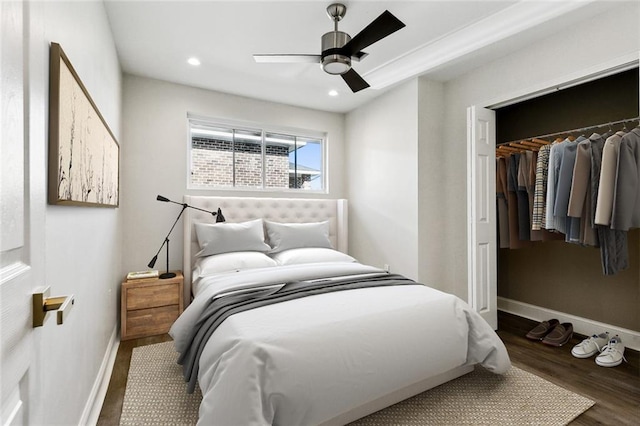 bedroom featuring ceiling fan, a closet, and dark wood-type flooring