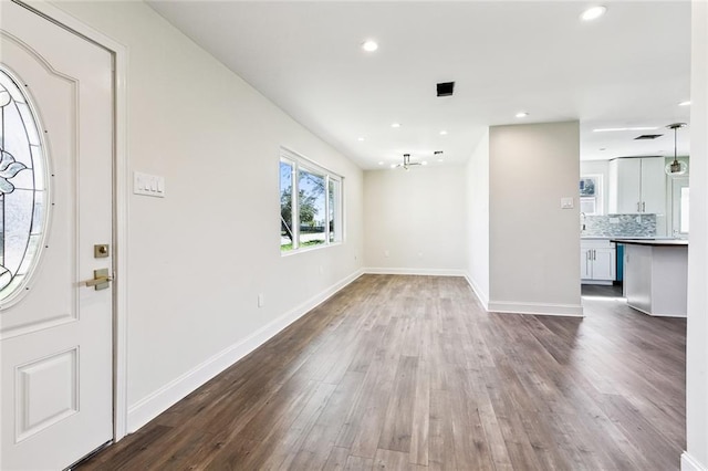 foyer entrance with ceiling fan and hardwood / wood-style flooring