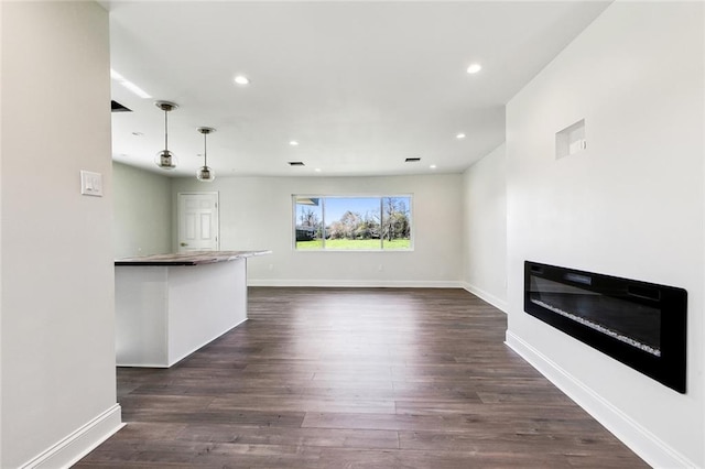 unfurnished living room featuring dark wood-type flooring