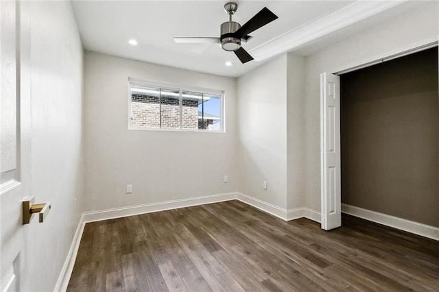 unfurnished bedroom featuring ceiling fan and dark hardwood / wood-style floors