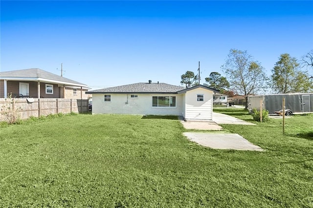 rear view of property with a lawn