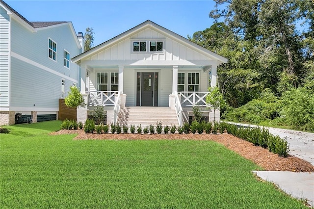 view of front of home with a front yard and a porch