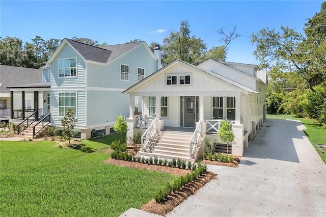 view of front of home with covered porch and a front yard