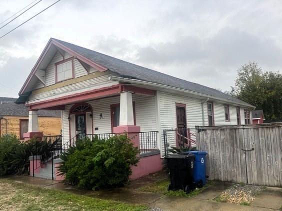 view of side of home with covered porch