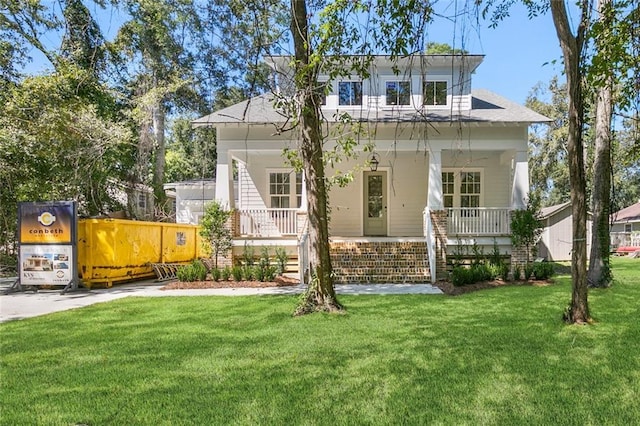 view of front of property with a porch and a front yard