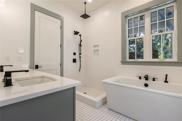 full bathroom featuring a freestanding tub, tiled shower, and vanity