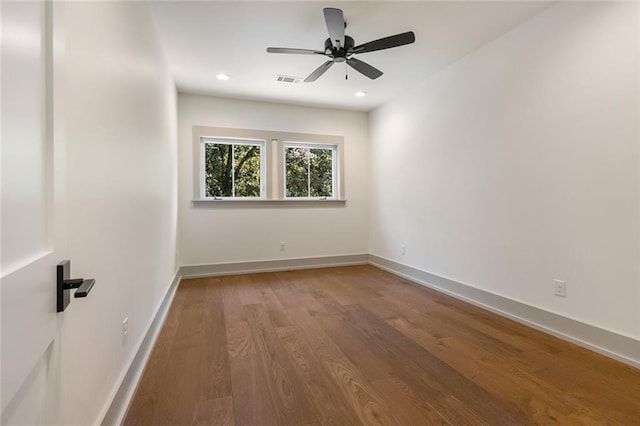 unfurnished room featuring recessed lighting, visible vents, baseboards, and wood finished floors