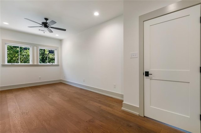 empty room with recessed lighting, wood finished floors, baseboards, and ceiling fan