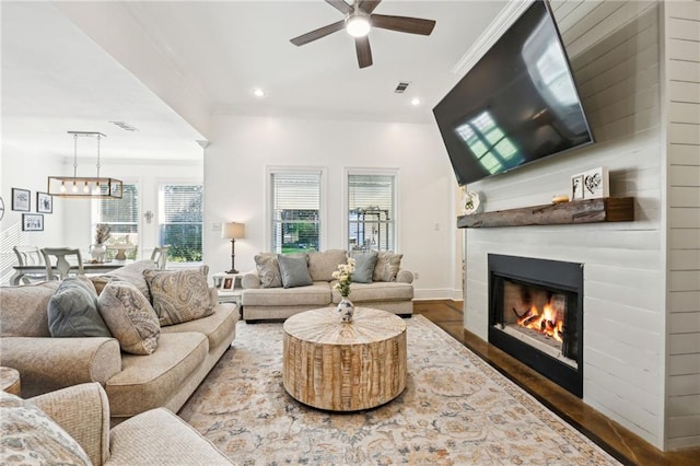 living room featuring hardwood / wood-style floors and ceiling fan