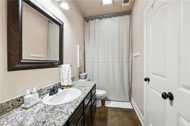 bathroom with toilet, vanity, and walk in shower