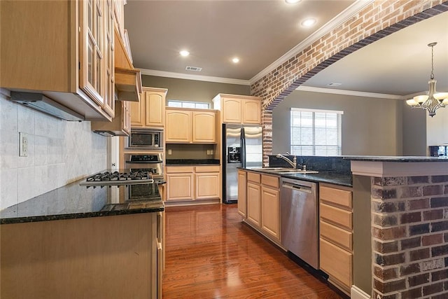 kitchen with sink, decorative light fixtures, dark hardwood / wood-style flooring, stainless steel appliances, and brick wall