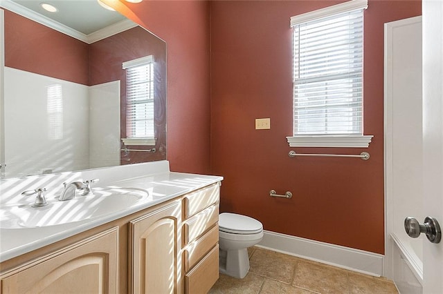 bathroom with plenty of natural light, toilet, crown molding, and vanity